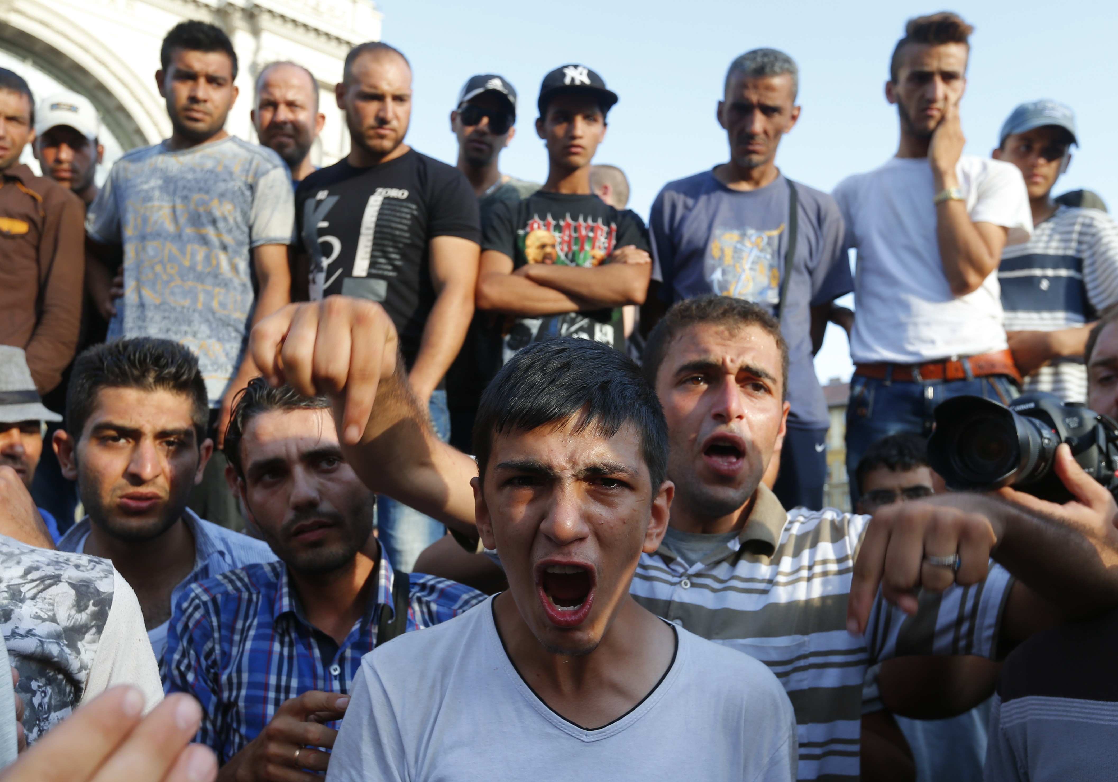 Amam, a17-year-old refugee from the Syrian town of Latakia shouts after his sister and mother were detained by Hungarian police outside the railways station in Budapest, Hungary September 2, 2015. Hundreds of migrants protest in front of Budapest's Keleti Railway Terminus for a second straight day on Wednesday, shouting "Freedom, freedom!" and demanding to be let onto trains bound for Germany from a station that has been closed to them by Hungarian riot police officers.  REUTERS/Laszlo Balogh         (Newscom TagID: rtrlseven280456.jpg) [Photo via Newscom]